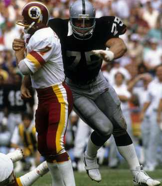 Long hits Joe Theismann in Super Bowl XVIII.